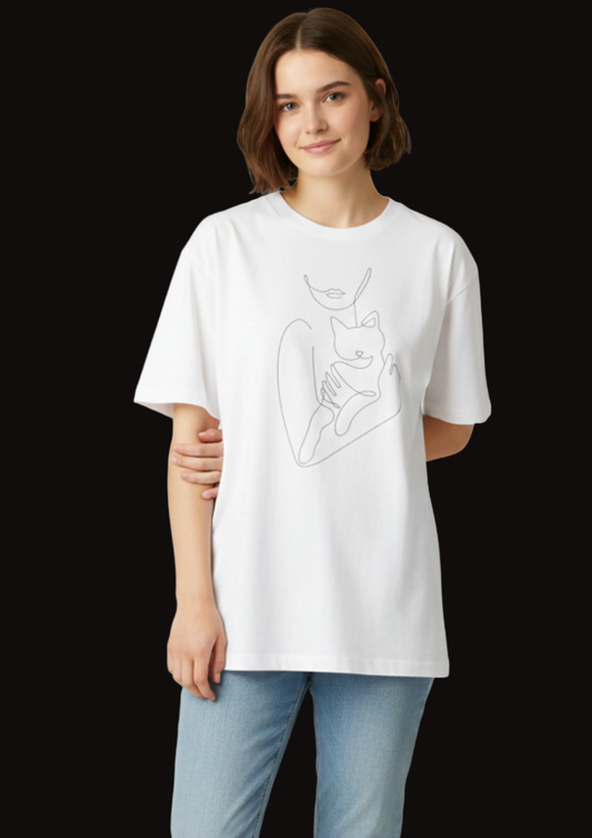 Person wearing a white t-shirt with a graphic design on a plain background