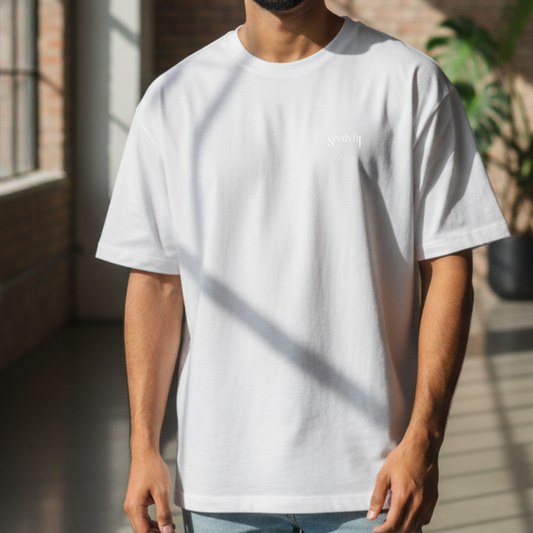 Person wearing a white t-shirt with a logo in an indoor setting